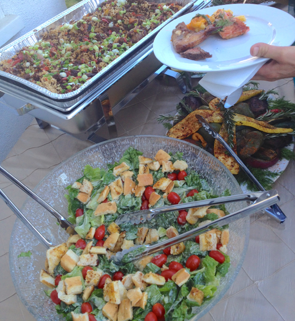 A Guest at Catered BBQ Wedding takes small servings of Smoked Waygu Steak and Salmon, leaving plenty of room on the plate for Salad and Grilled Veggies.